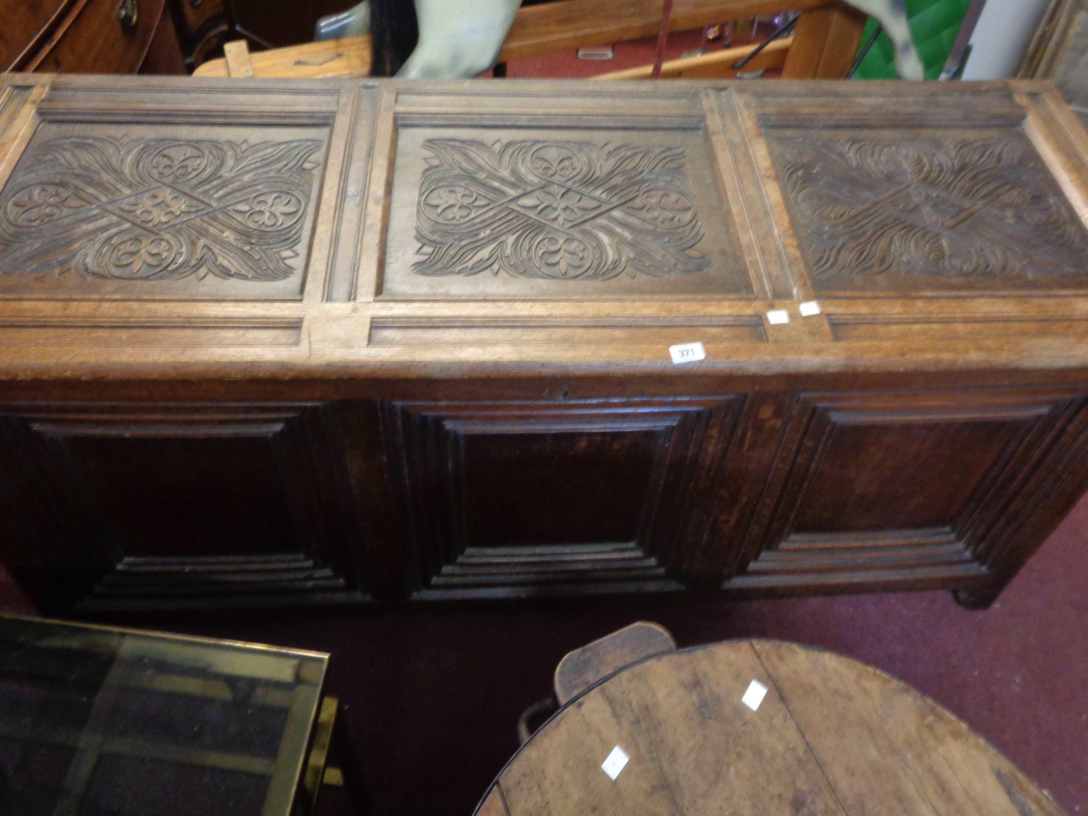 A 1.65m late 18th Century oak three panel coffer with hinged lift-top, set on raised feet
