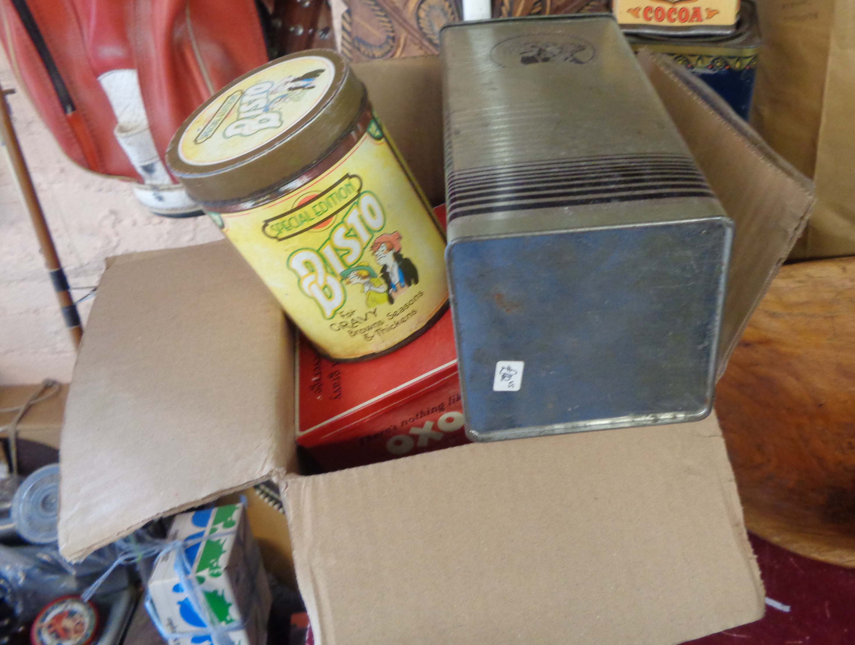 A box containing a quantity of vintage advertising tins, including French Twinings, Weetabix, etc.