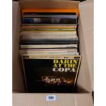 A box containing LP records including Bobby Darrin at the Copa, etc.