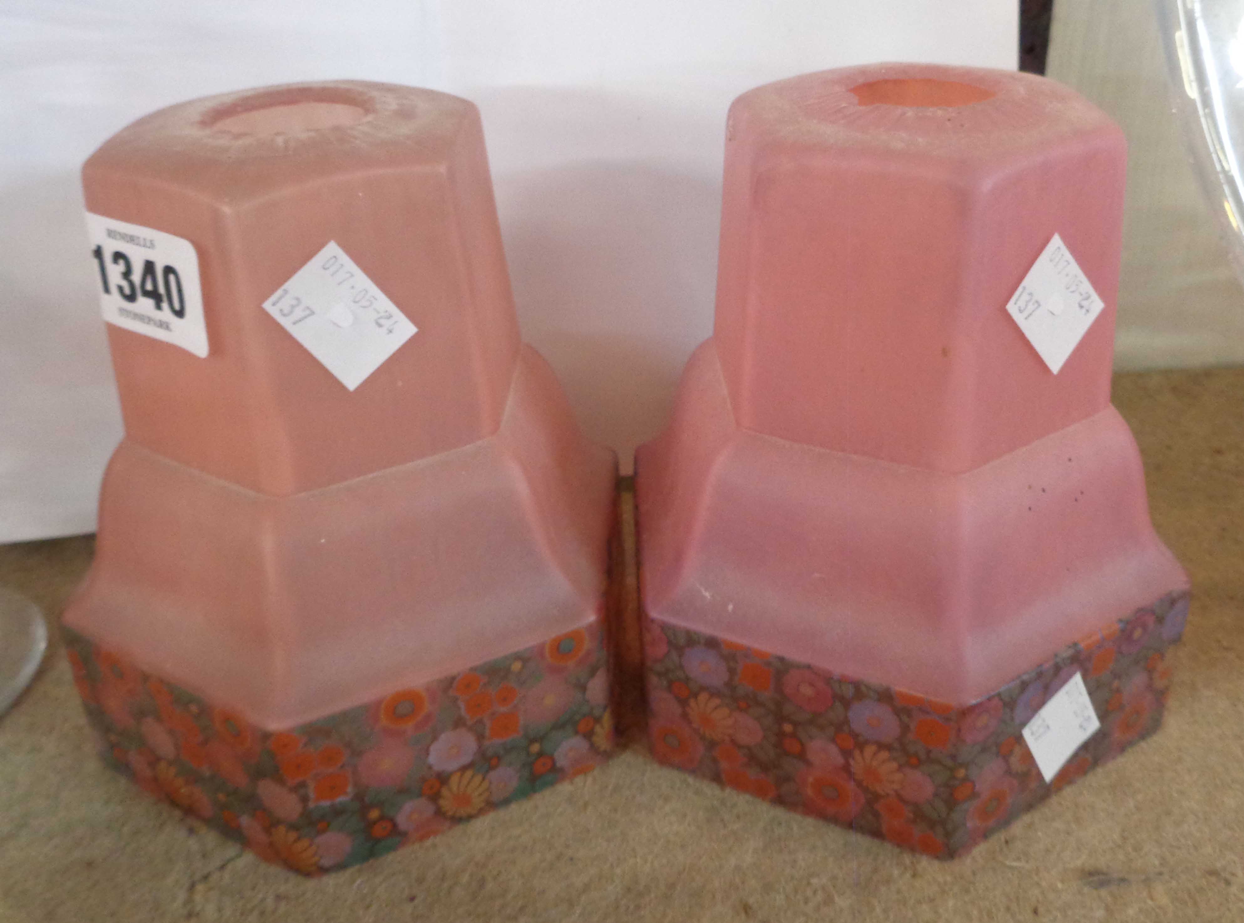 A pair of Art Deco glass lampshades with a band of flowers on a pink ground - one a/f