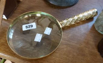 A large modern brass handled magnifier