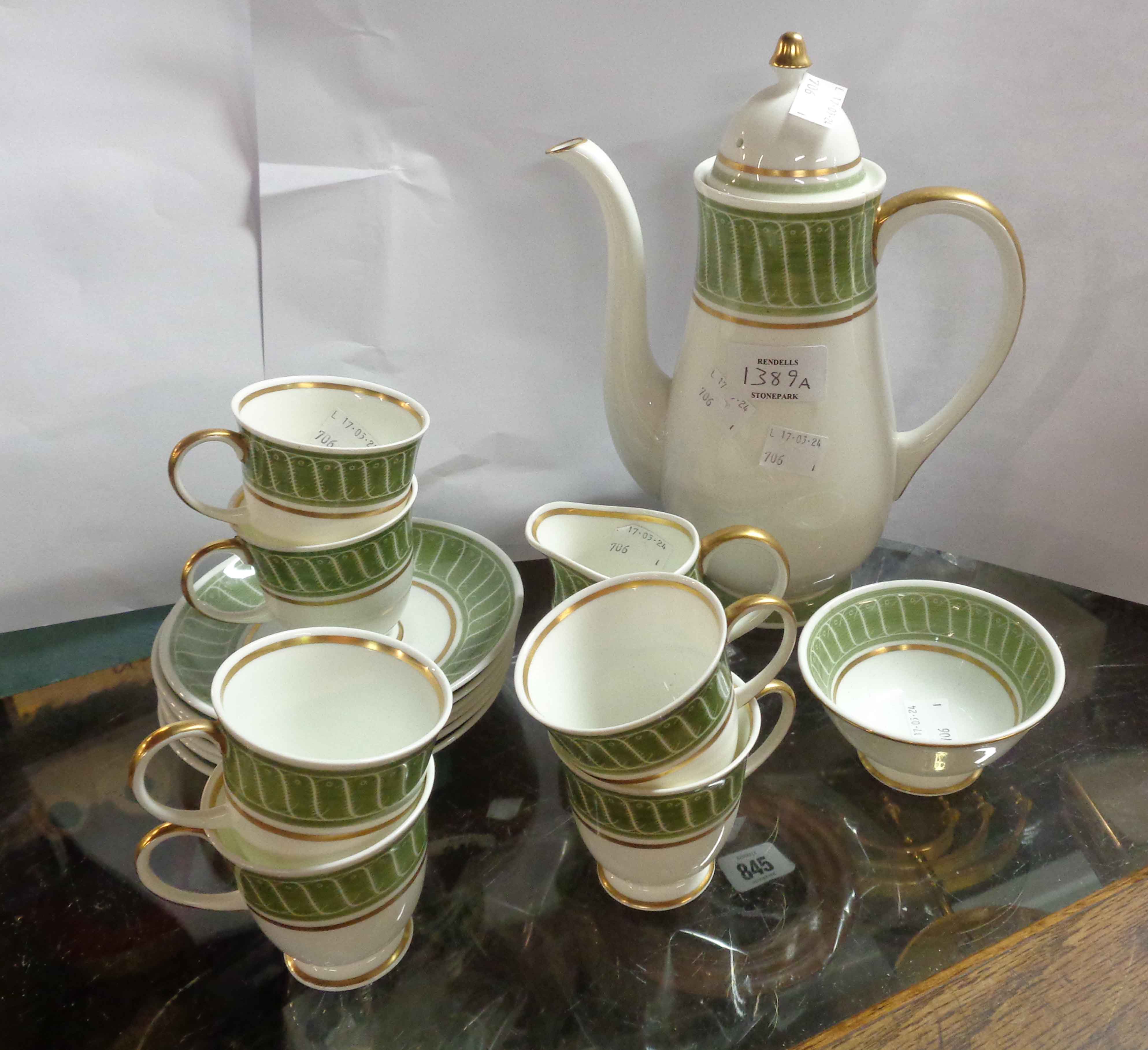 A Susie Cooper bone china part coffee set comprising coffee pot (a/f), six cups and saucers, cream