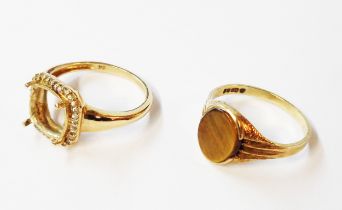 A 375 (9ct.) gold ring, set with flat oval tiger's-eye panel - sold with a 9ct. gold ring shank with