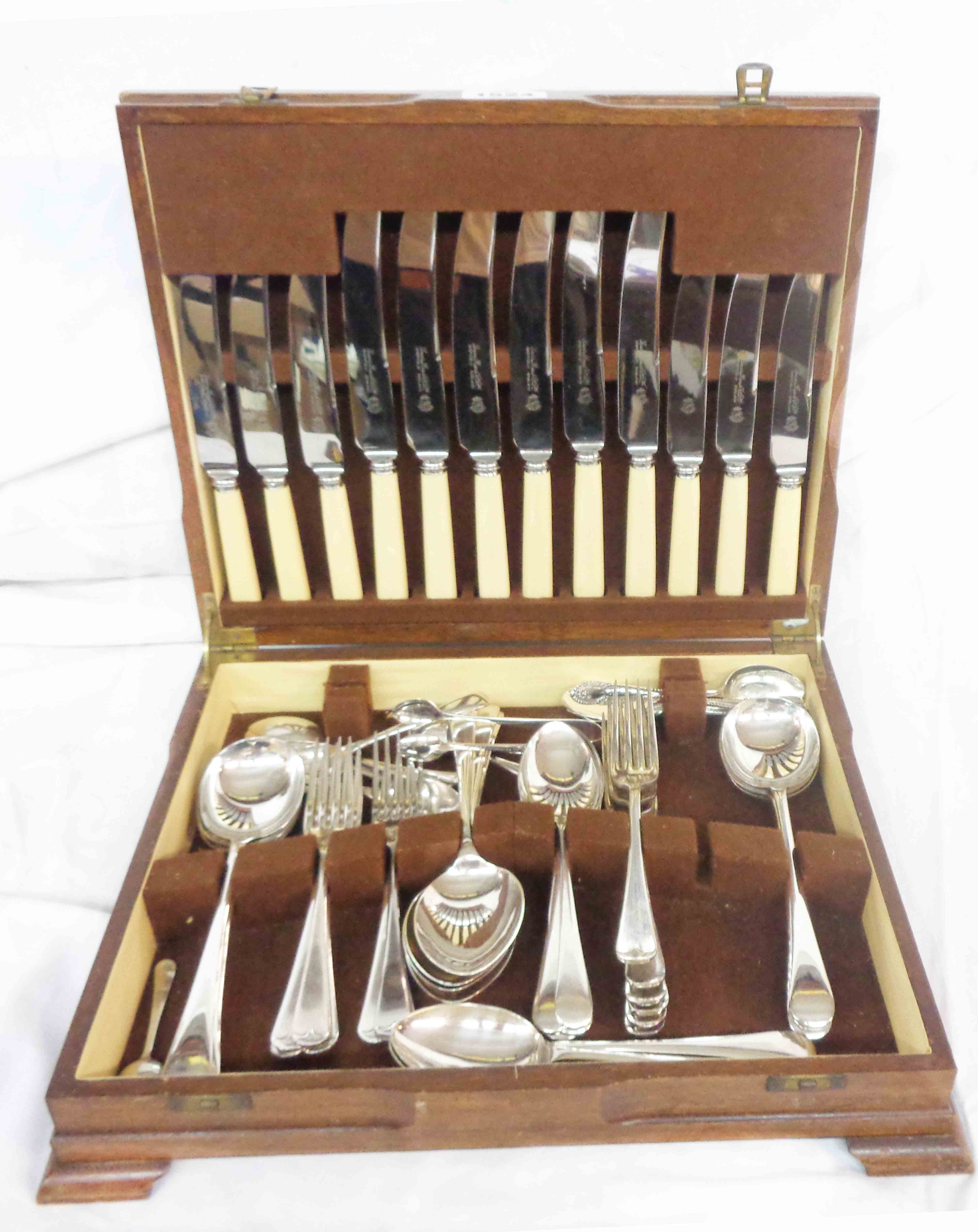A vintage quarter veneered canteen containing a part set of silver plated cutlery and other cutlery