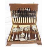 A vintage quarter veneered canteen containing a part set of silver plated cutlery and other cutlery