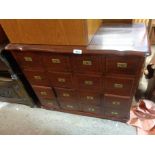 A 75cm modern stained hardwood CD storage chest with sixteen fitted drawers, each with brass flush