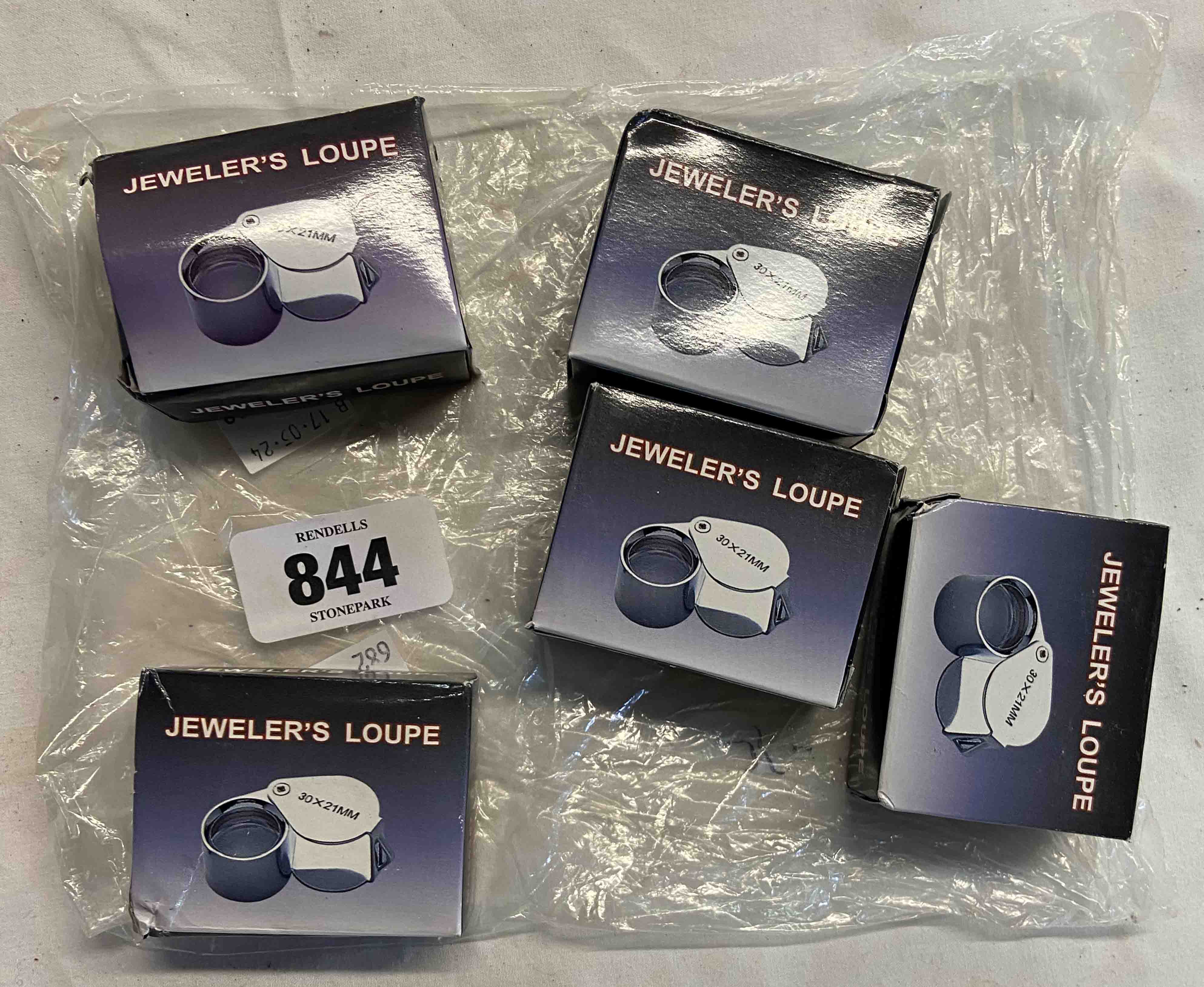 A bag containing five new in box jeweller's loupes