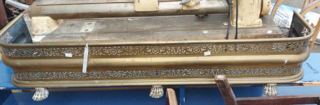 A decorative brass fire fender with pierced gallery