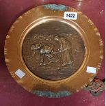 A copper plate with central embossed panel, depicting three women working a field with clipped edge