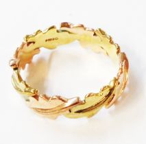 A 375 (9ct.) rose and yellow gold band with all round oak leaf decoration - size Q - boxed