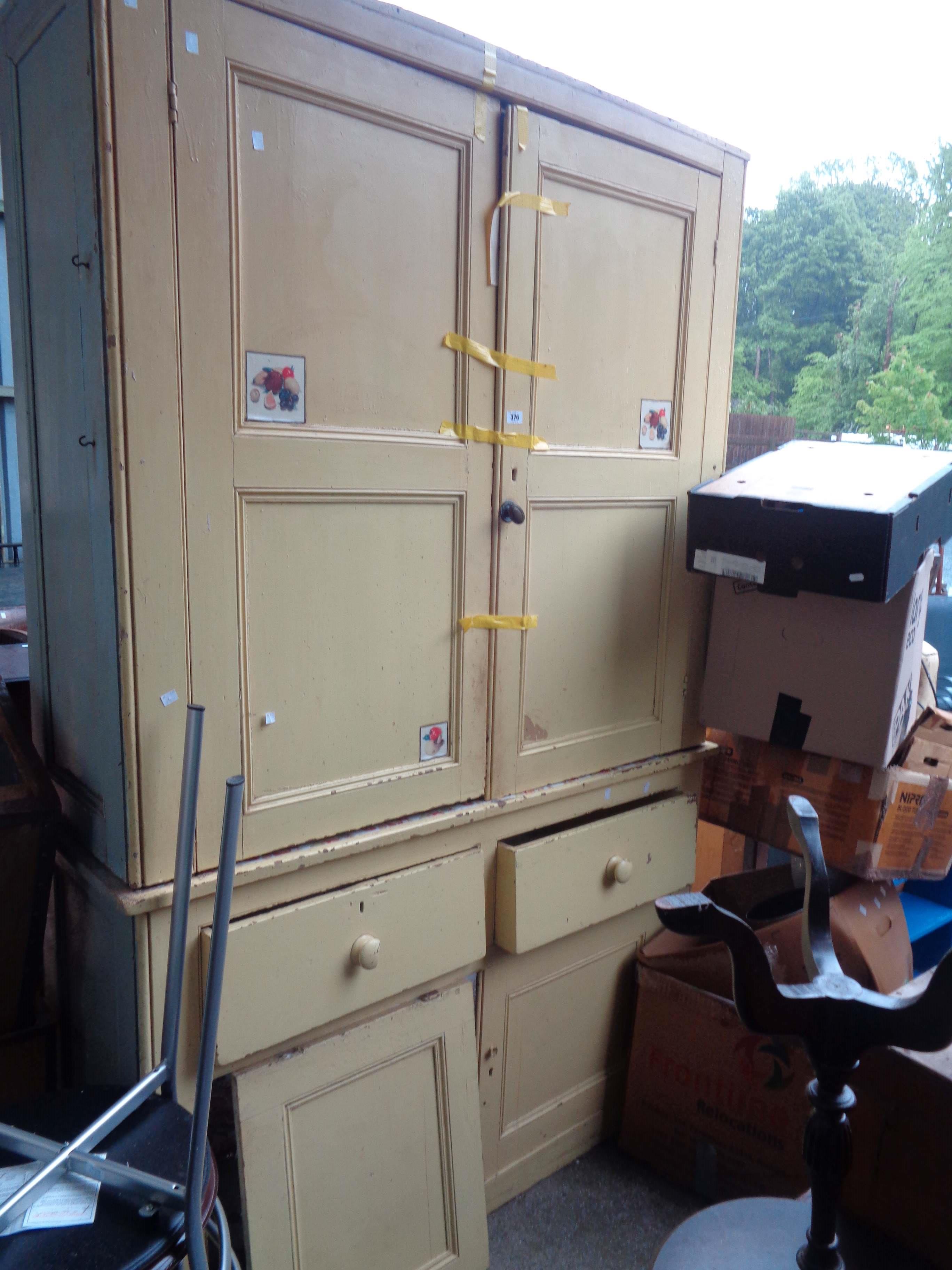 A 1.43m Victorian later yellow painted two part housekeeper's cupboard with shelves enclosed by a