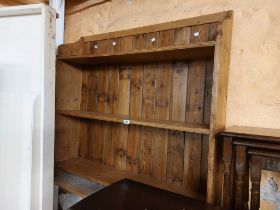A 1.12m rustic stripped pine three shelf open bookcase