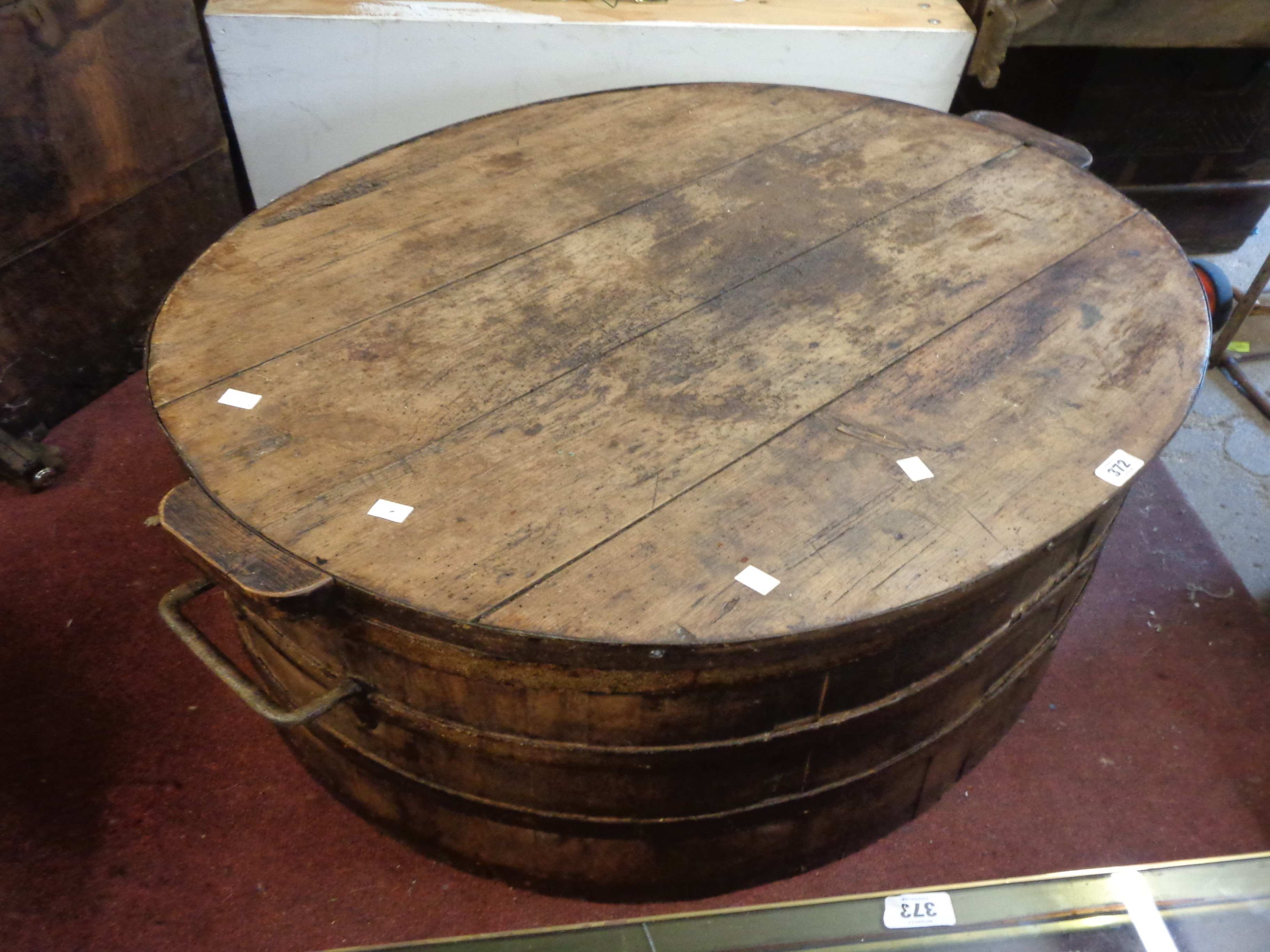 An old coopered pine pig salter with sit-on lid and flanking iron handles