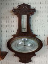 An early 20th Century carved mahogany framed banjo barometer/thermometer with silvered dial marked