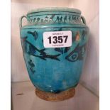 An old Persian pottery vase with hand painted fish decoration on a turquoise glaze ground - a/f