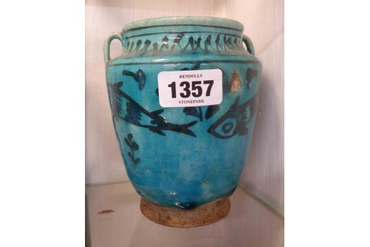 An old Persian pottery vase with hand painted fish decoration on a turquoise glaze ground - a/f