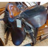 A Triumph Princess junior leather saddle - sold with two whips