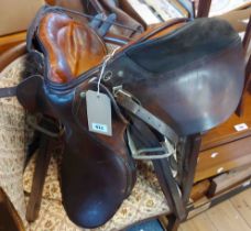 A Triumph Princess junior leather saddle - sold with two whips