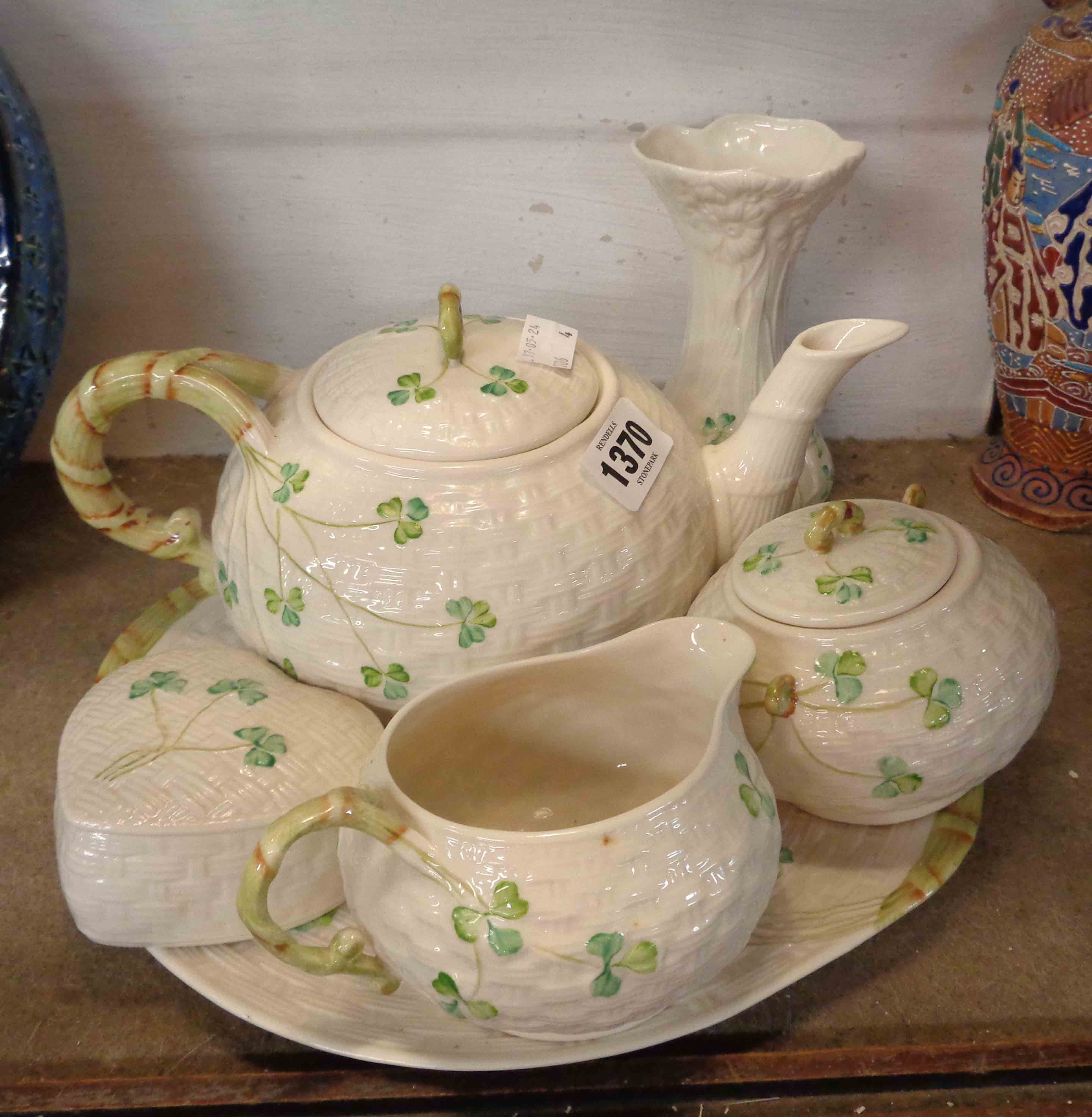 A quantity of Belleek porcelain comprising teapot, milk jug, sucrier, bread and butter plate,