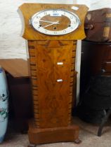 An Art Deco figured walnut cased grandmother clock, with later quartz musical movement