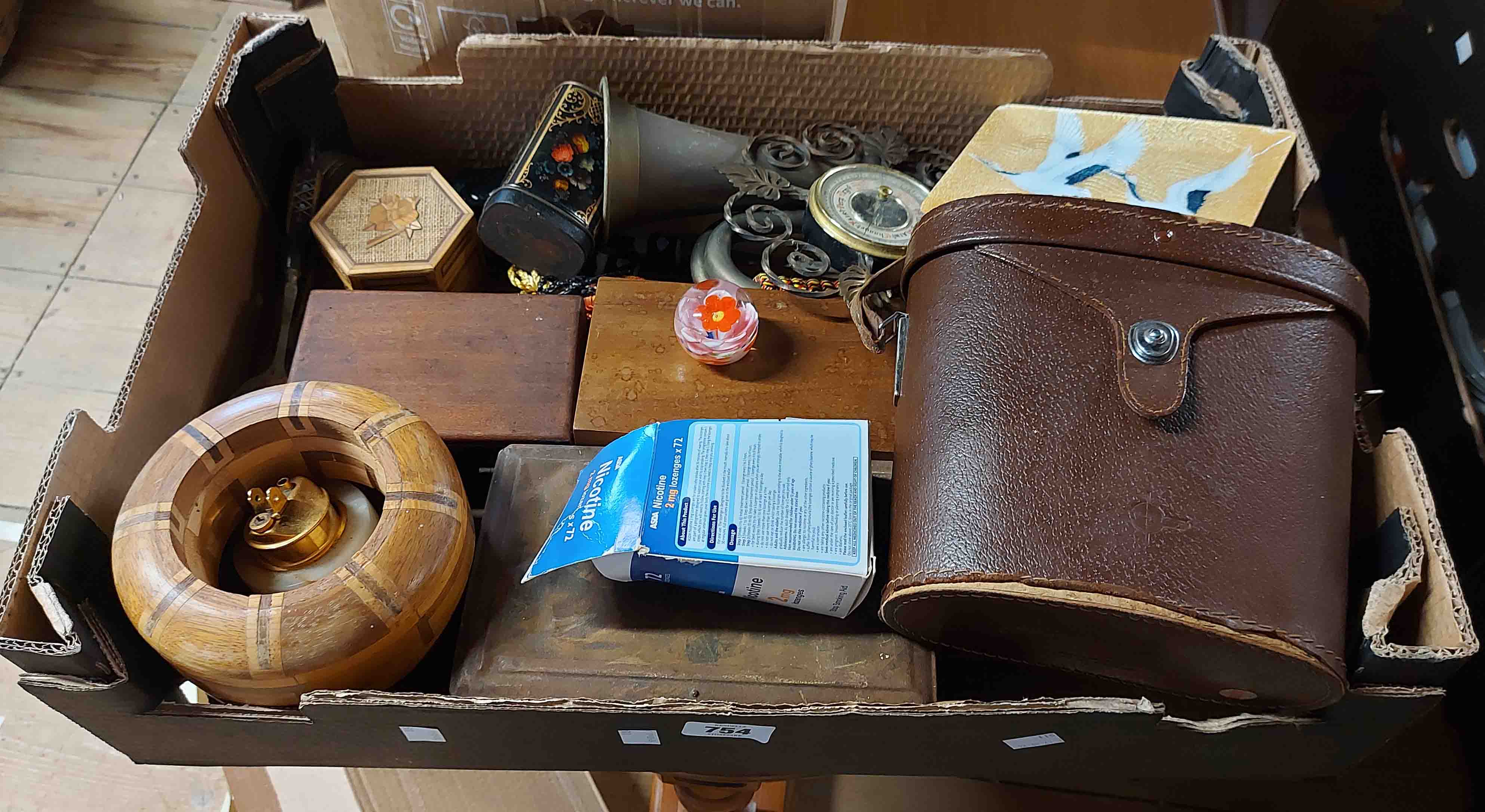 A box containing a quantity of collectable items including small glass paperweight, cased