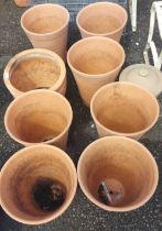 Eight terracotta pots and a stoneware bread crock