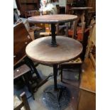 A 68cm diameter vintage two tier tavern table, set on a pierced cast iron base