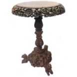 A 55cm diameter old Burmese stained paduk wood occasional table with pierced foliate frieze and
