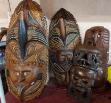 Four carved masks comprising two Kenyan and two Indonesian Jalat examples