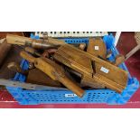 A crate containing a quantity of woodworking tools including planes, hand vices, etc.