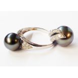 A 375 (9ct.) white gold black pearl solitaire ring - sold with matching pendant with two rows of