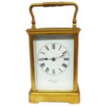 A late 19th Century gilt brass and bevelled glass cased carriage timepiece with dial marked for '