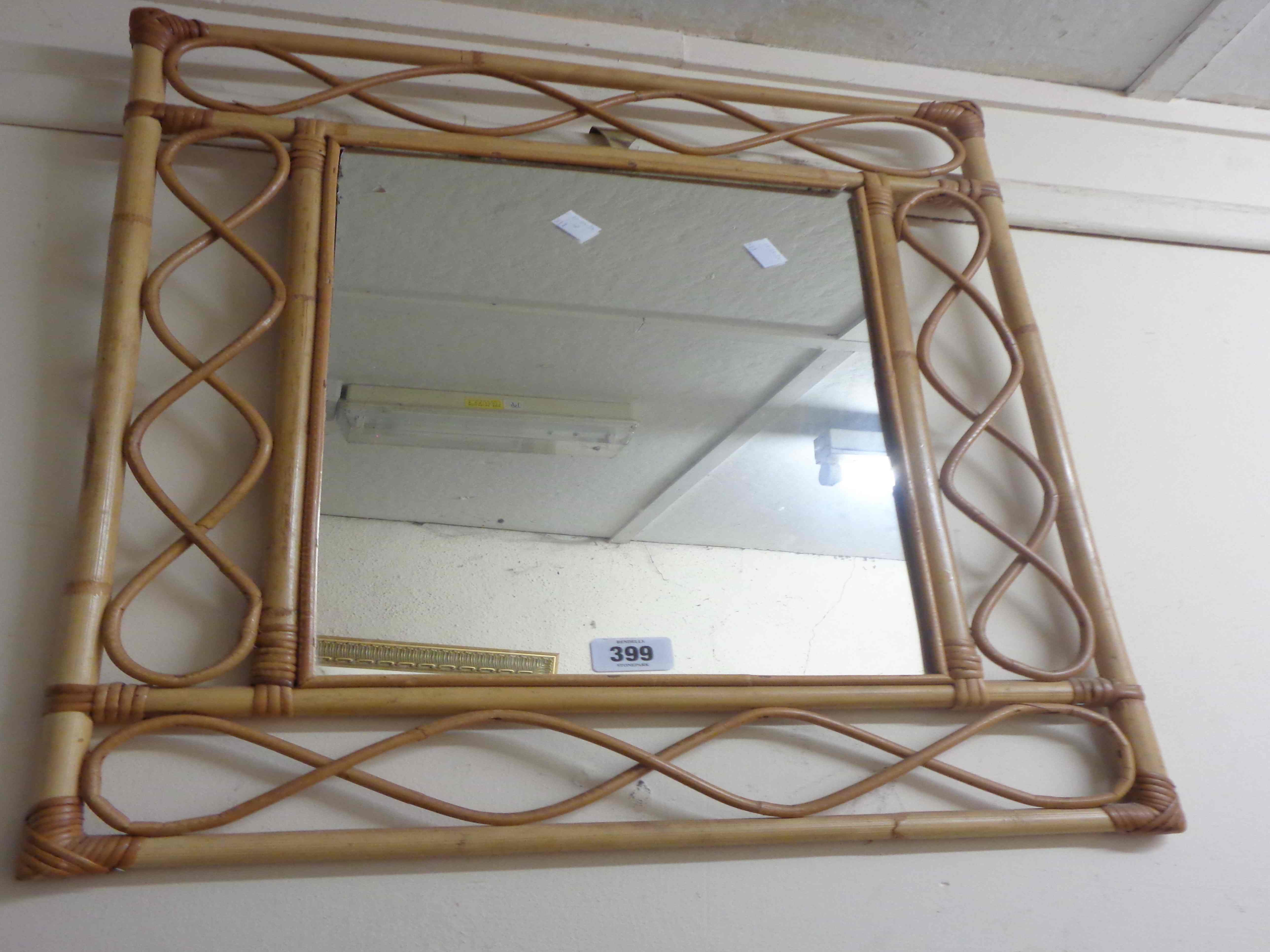 A modern bamboo framed oblong wall mirror