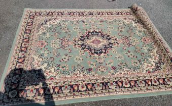 A modern rug with floral decoration on a green ground