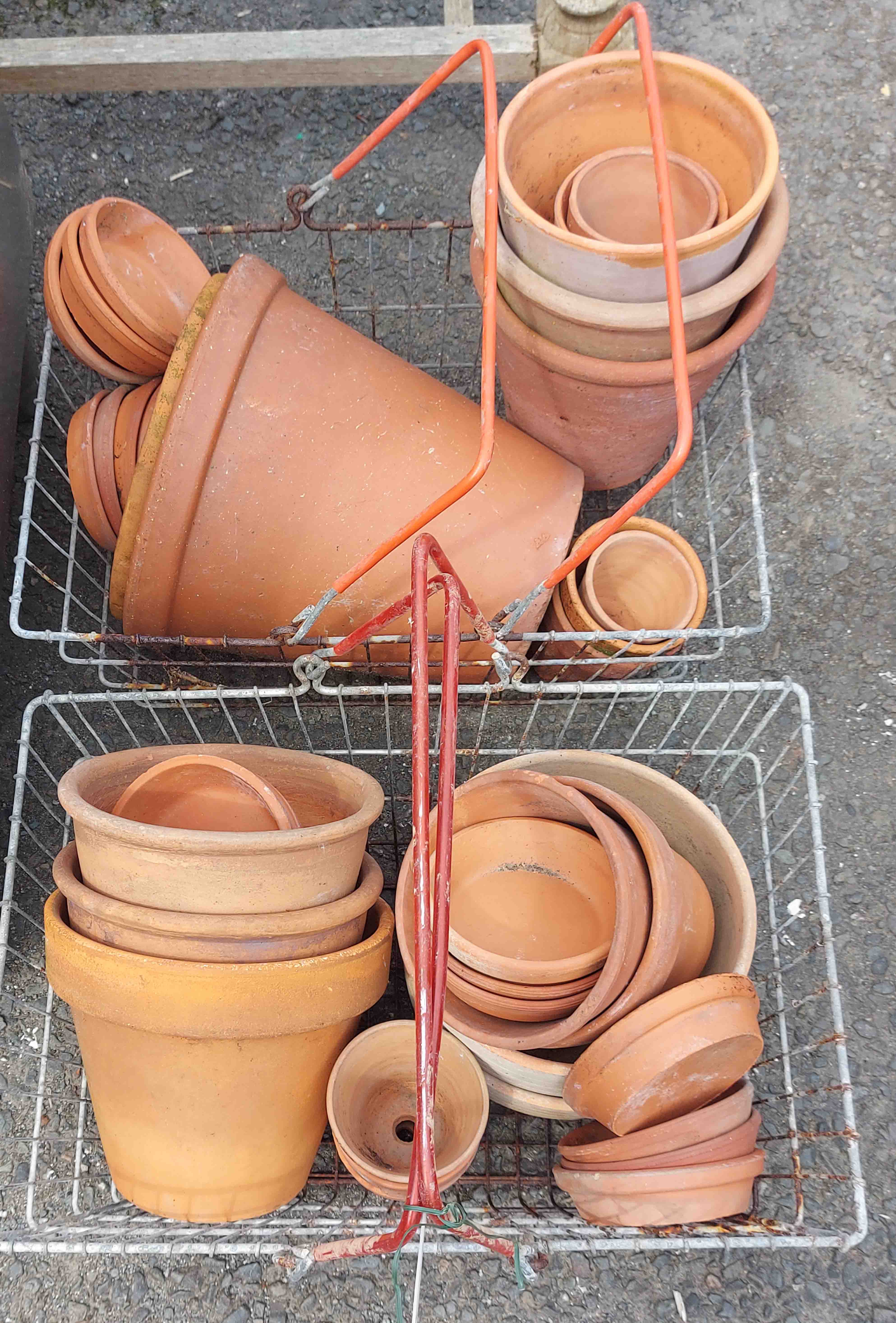 Two baskets of terracotta pots