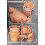 Two baskets of terracotta pots