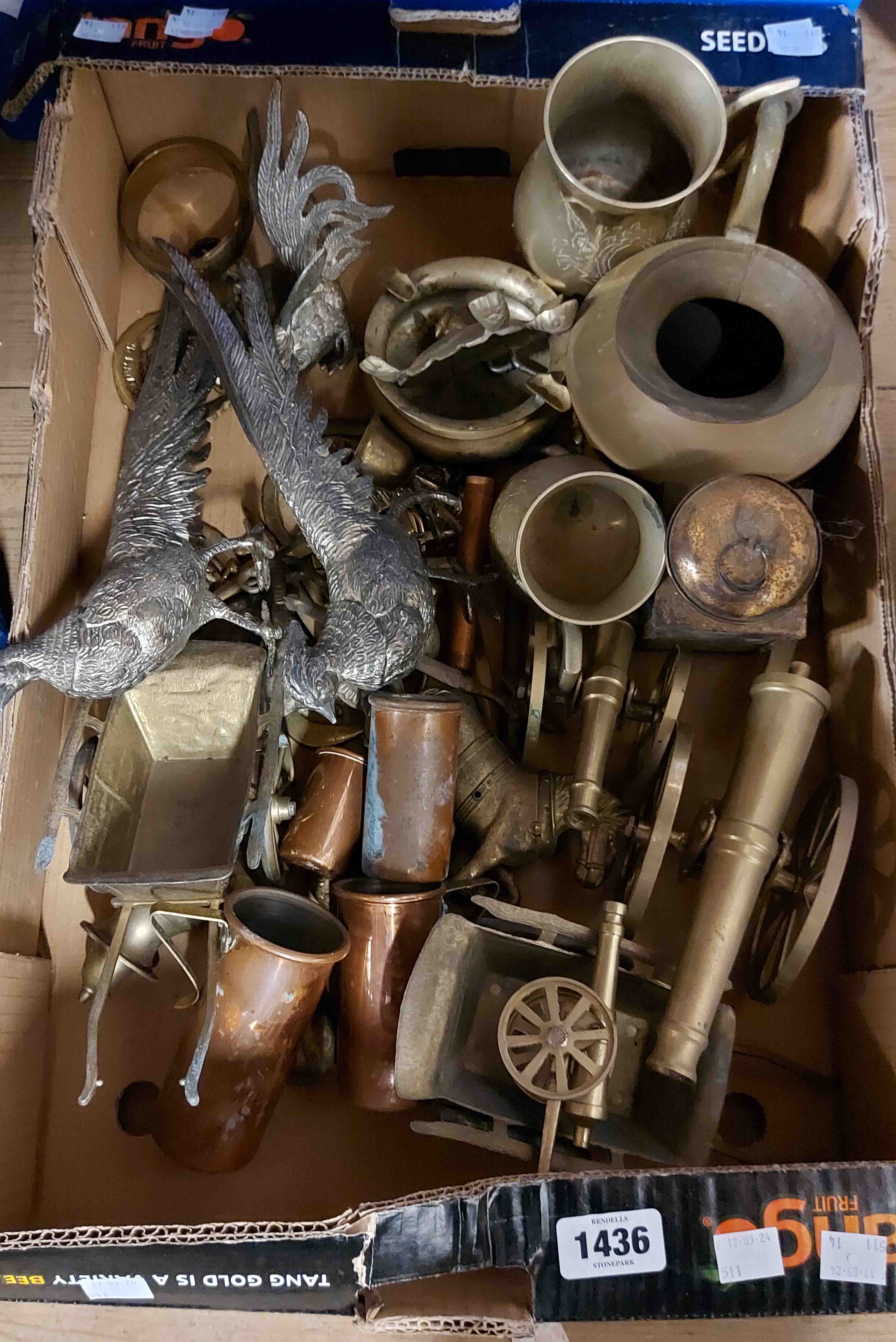 A box containing a quantity of metalware including ornamental brass cannons, spelter pheasants,