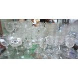 An Edwardian part suite of table glassware with cut and polished floral decoration including