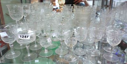 An Edwardian part suite of table glassware with cut and polished floral decoration including