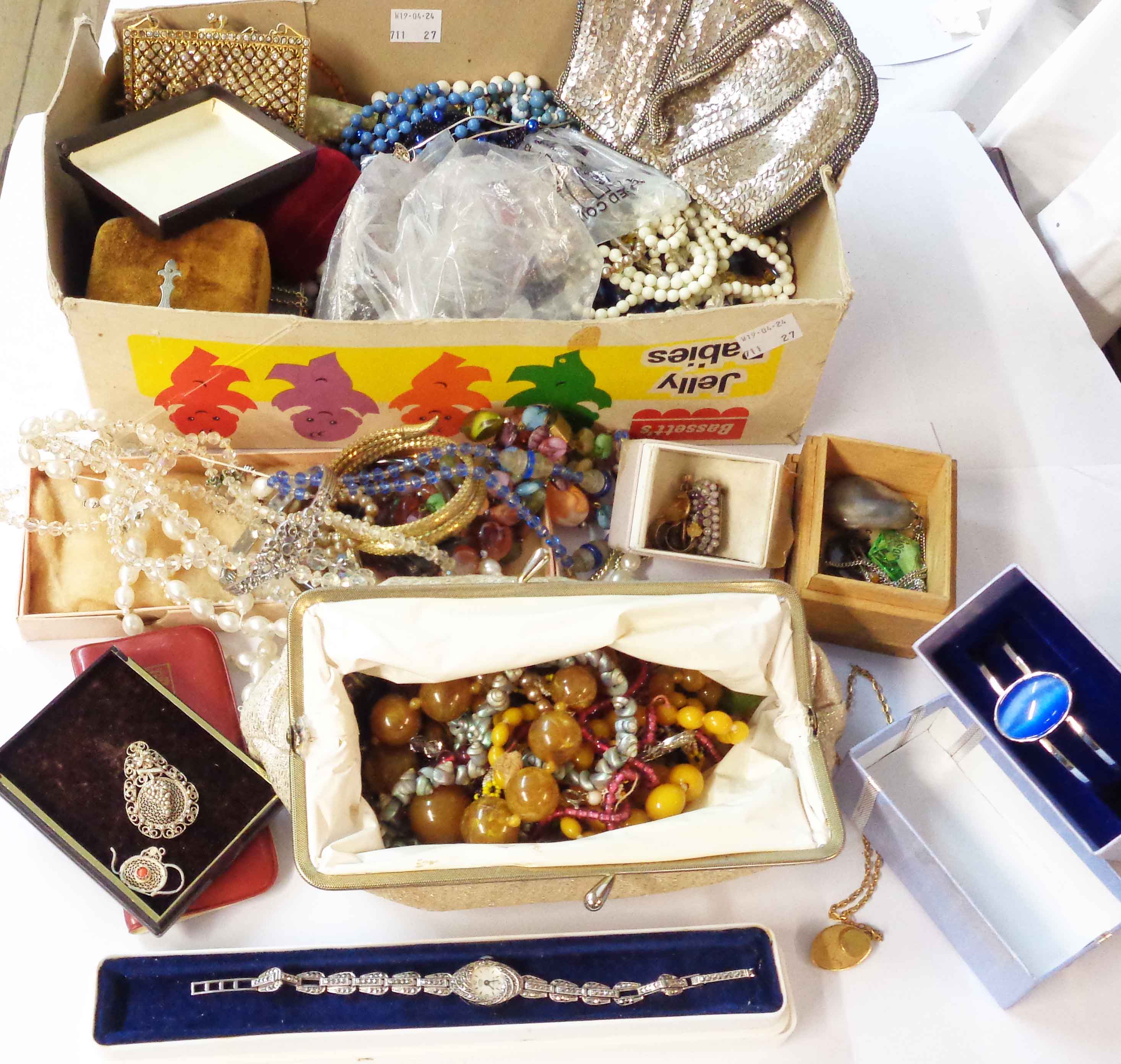 A box containing a quantity of vintage and later costume and other jewellery, modern steel cased