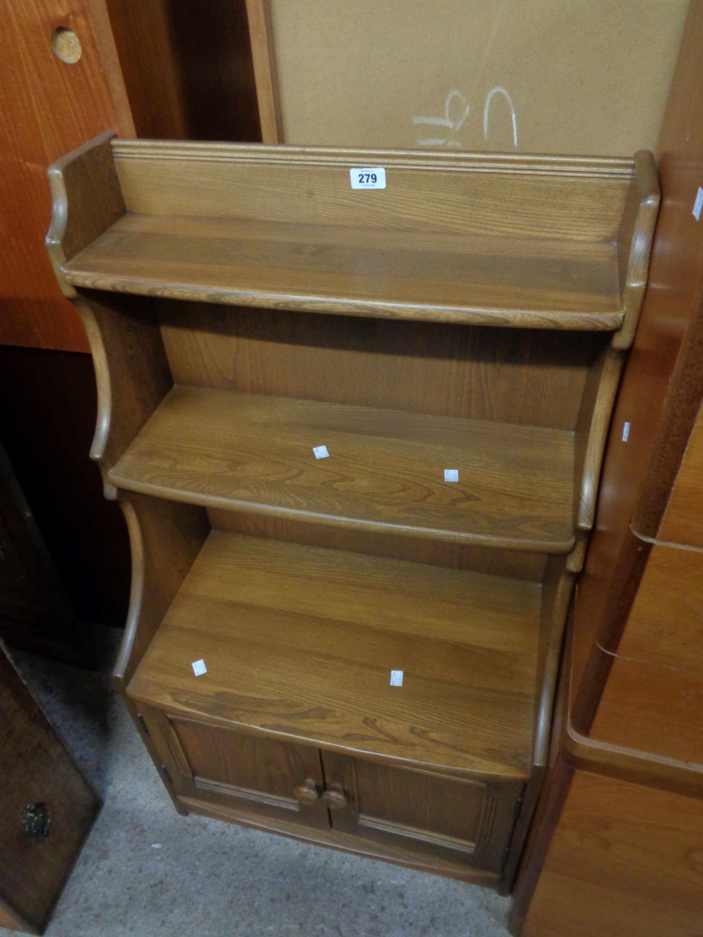 A 60cm Ercol dark elm three shelf waterfall open bookcase with double cupboard under, set on