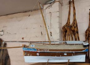 A vintage model fishing sailboat 'Lamu' set on wooden stand