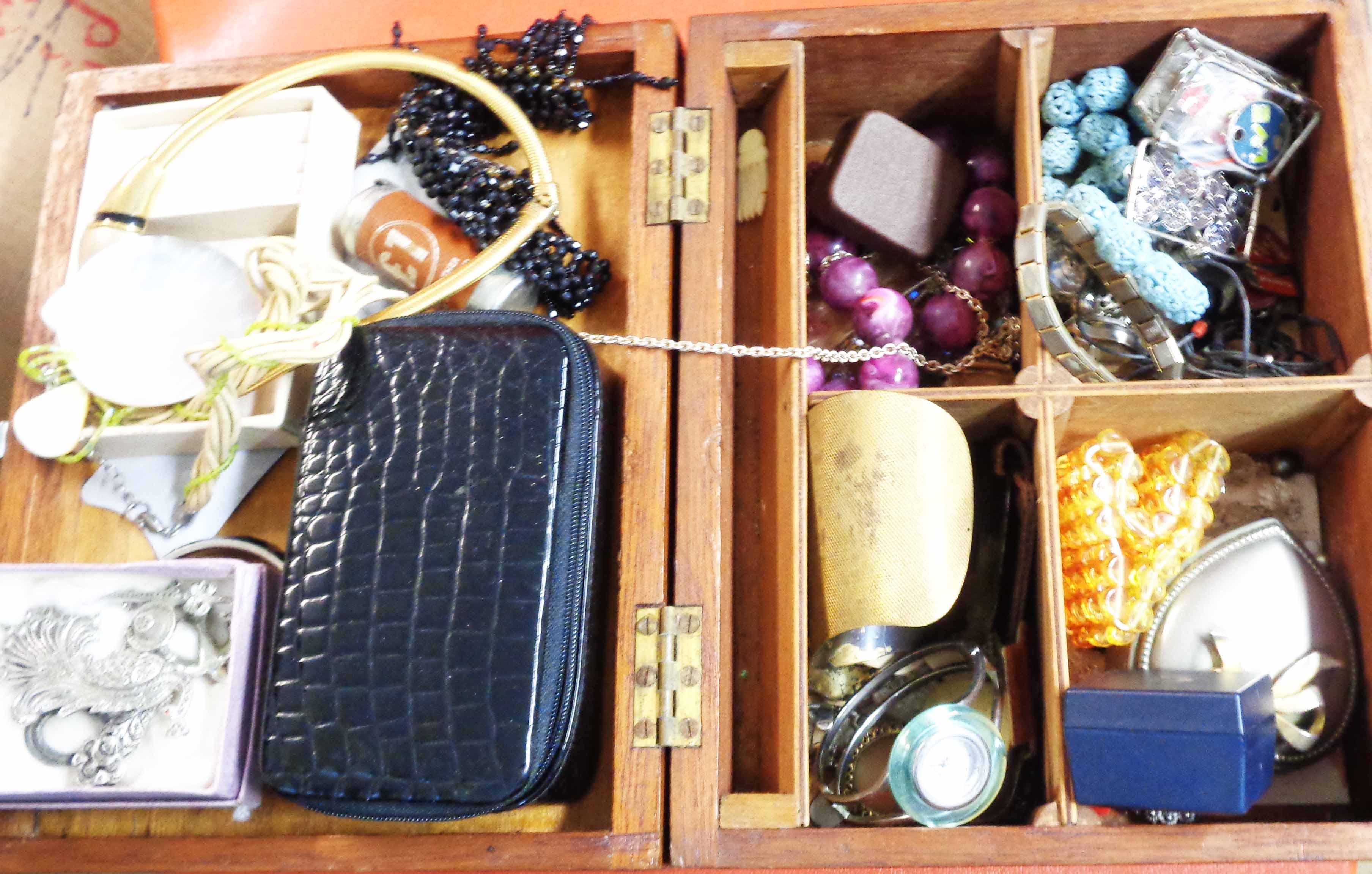 A wooden lift-top box containing a quantity of assorted costume jewellery, two decorative trinket