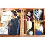 A wooden lift-top box containing a quantity of assorted costume jewellery, two decorative trinket