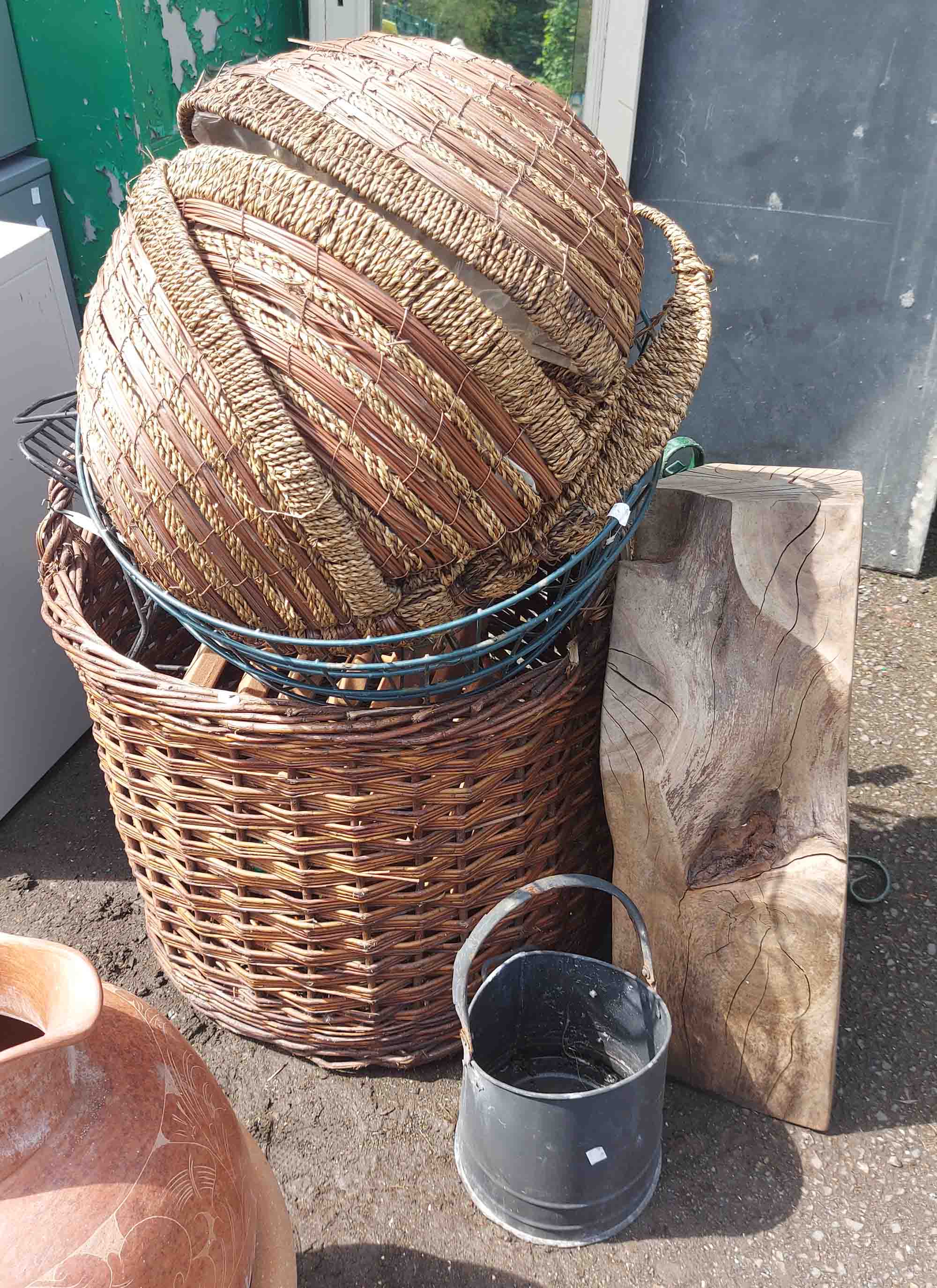 A large wicker baskets a Christmas tree stand, wood block, etc.