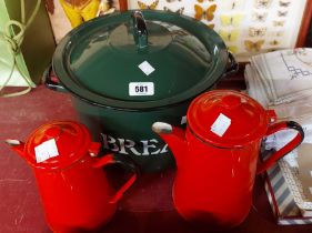 A green enamelled bread bin - sold with two red enamelled coffee pots