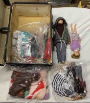 A small black case containing vintage Cimely dolls and accessories