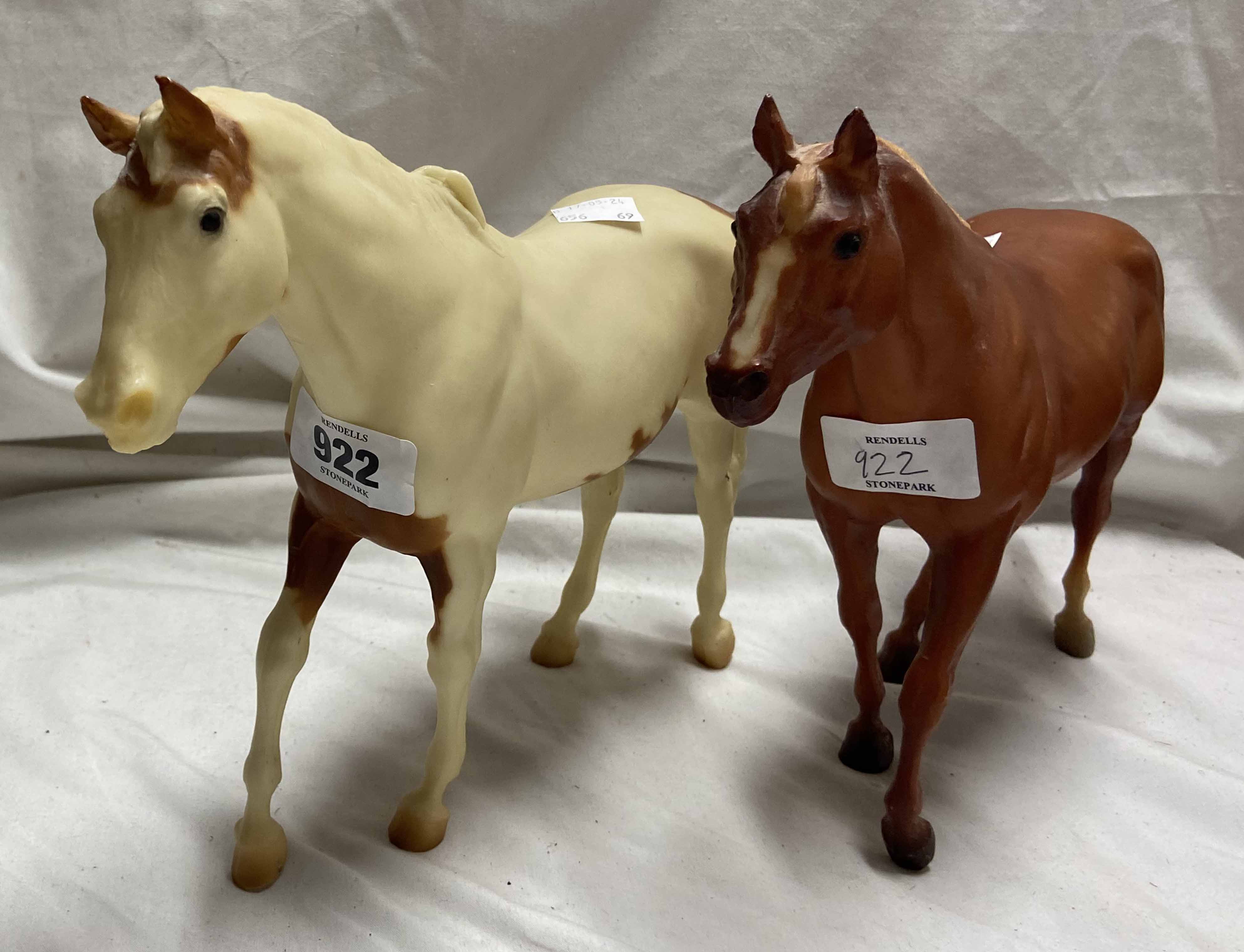 Two Breyer horses one skewbald, the other pure brown
