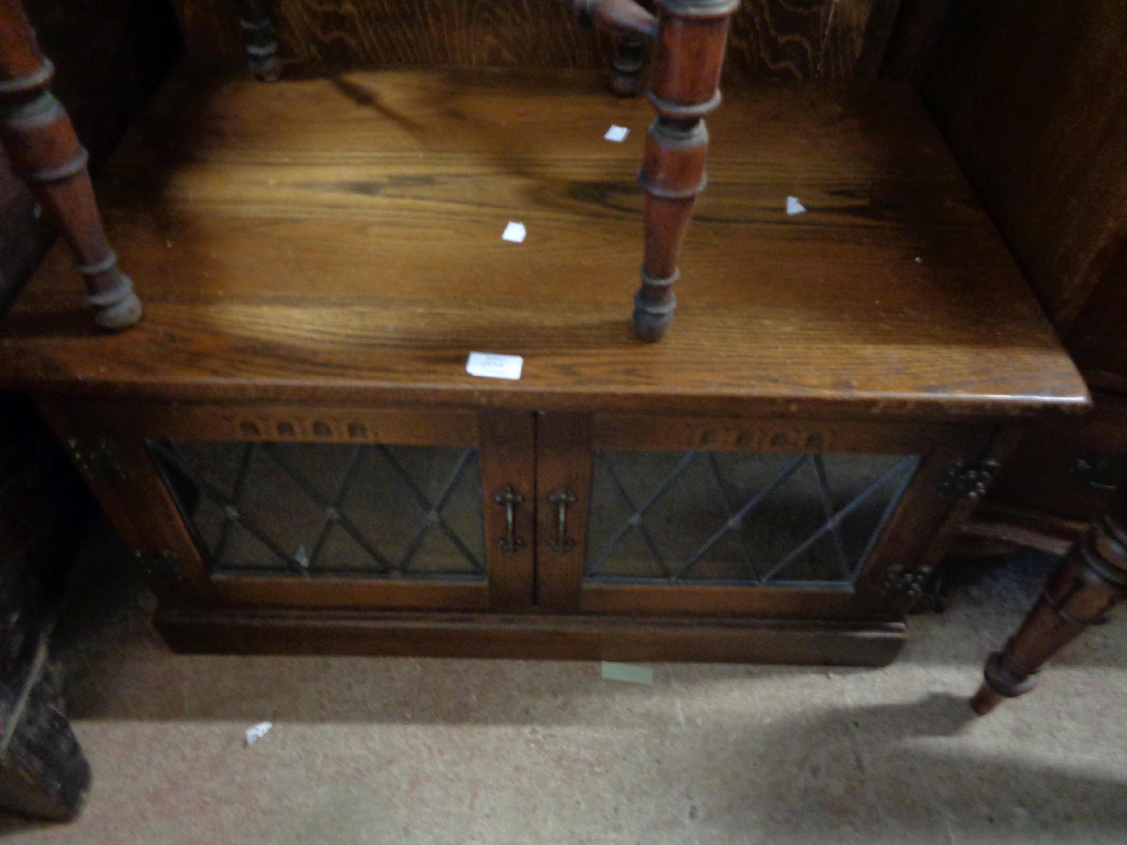 An 81cm vintage Webber Furniture oak media cabinet with leaded glazed panel doors