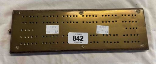A brass mounted wooden cribbage board
